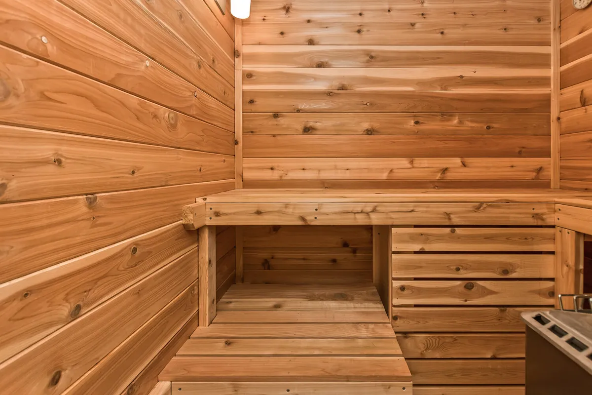A private dry sauna with wooden benches and walls, softly lit to create a peaceful and immersive spa-like experience. The enclosed, warm environment is perfect for unwinding after a day of adventure.